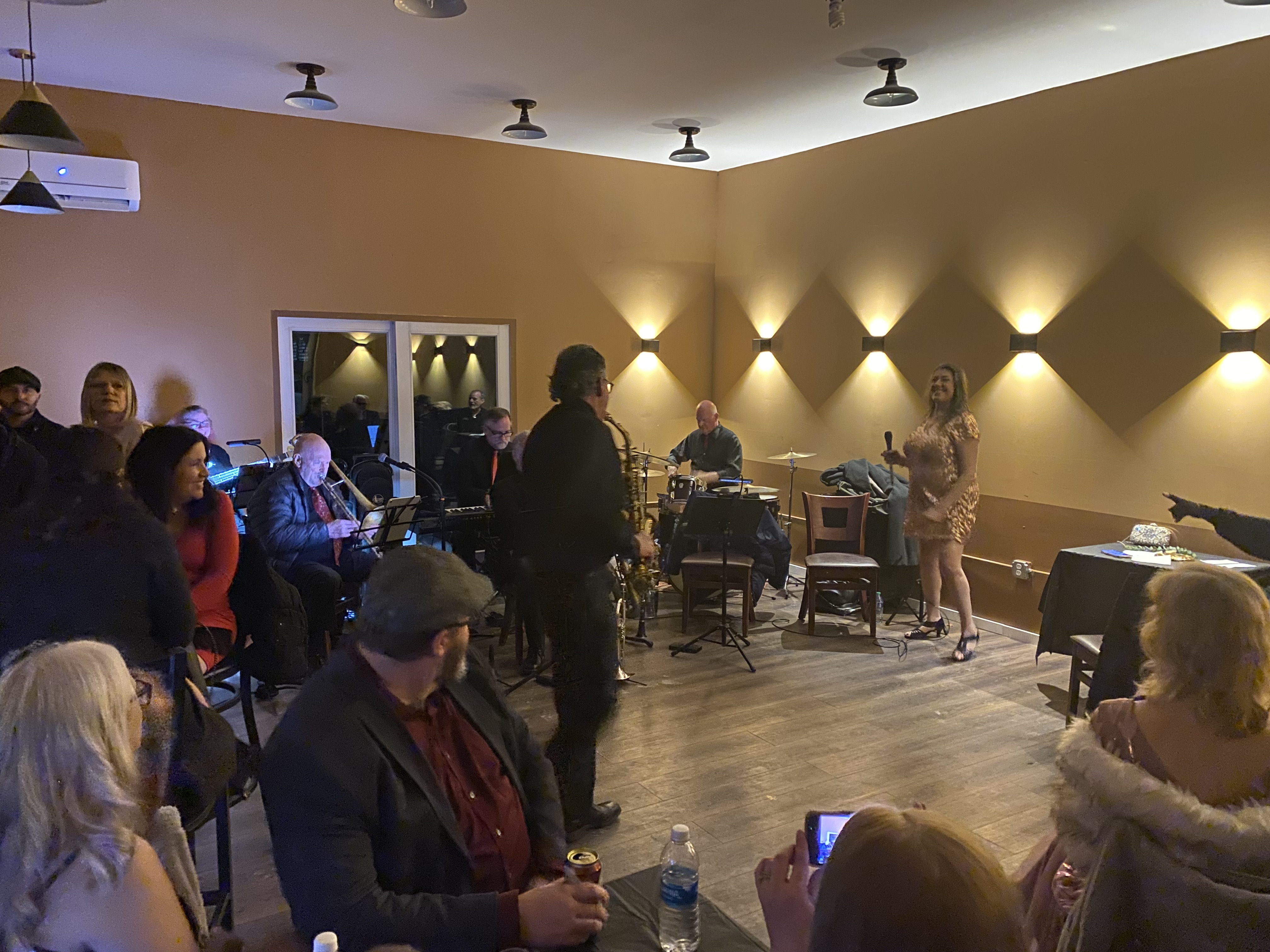 A picture of the saxophonist dancing while playing.